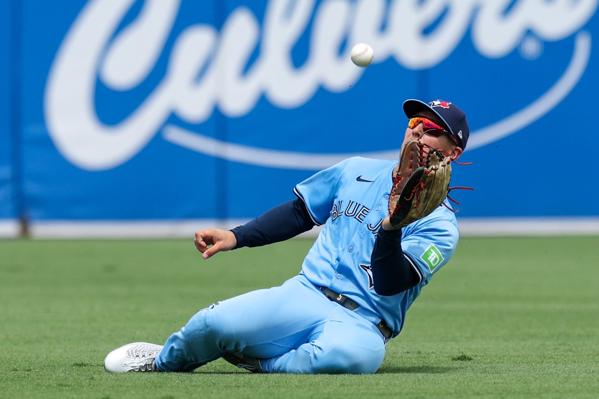 Sep 18, 2025; Tampa, Florida, USA; Toronto Blue Jays center fielder Daulton Varsho (5) makes a sliding catch against the Tampa Bay Rays in the fourth inning at George M. Steinbrenner Field. Mandatory Credit: Nathan Ray Seebeck-Imagn Images