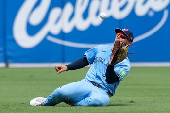 Sep 18, 2025; Tampa, Florida, USA; Toronto Blue Jays center fielder Daulton Varsho (5) makes a sliding catch against the Tampa Bay Rays in the fourth inning at George M. Steinbrenner Field. Mandatory Credit: Nathan Ray Seebeck-Imagn Images