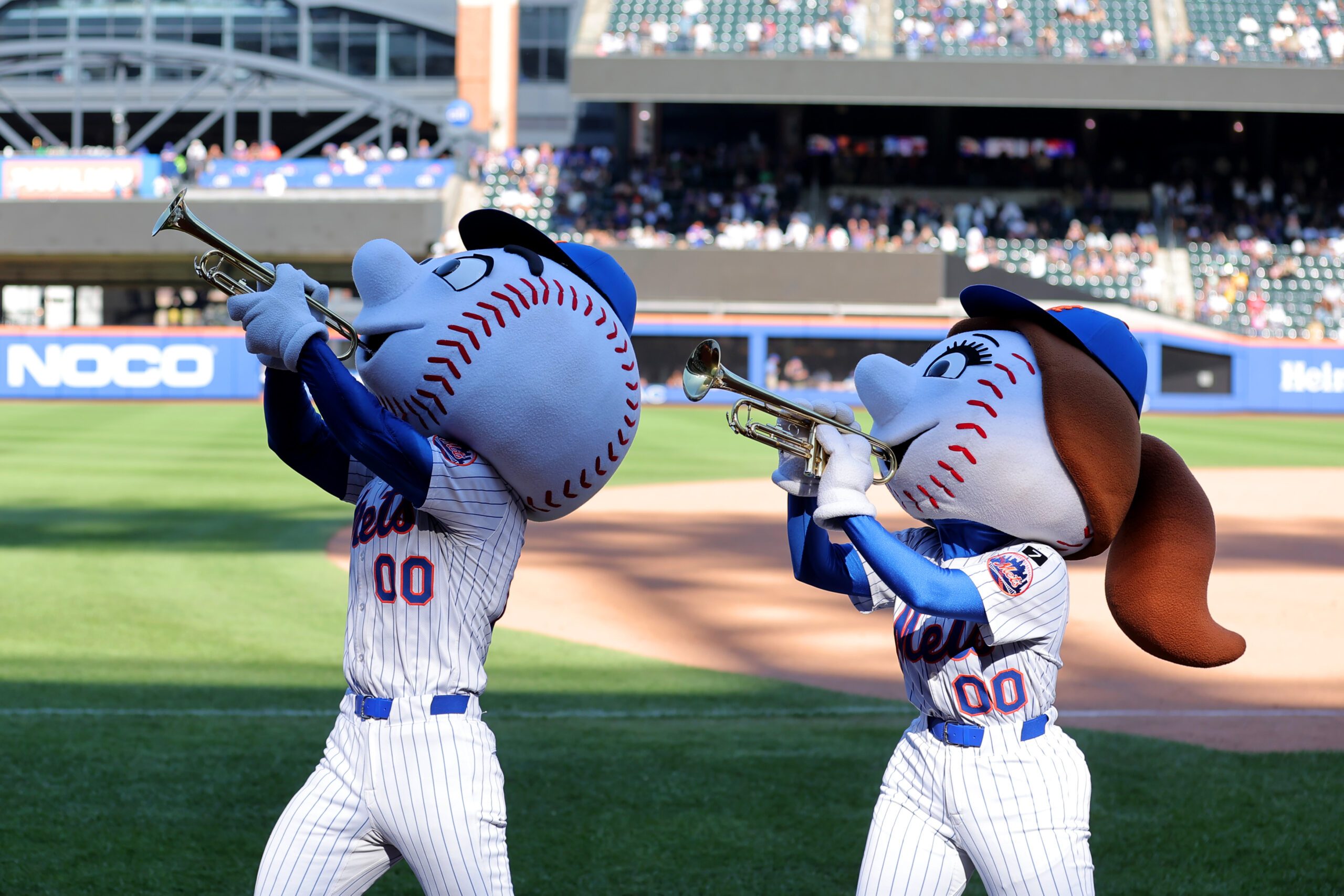 Sep 18, 2025; New York City, New York, USA; Mr. and Mrs. Met play the trumpets as New York Mets relief pitcher Edwin Diaz (not pictured) enters the game against the San Diego Padres during the ninth inning at Citi Field. Mandatory Credit: Brad Penner-Imagn Images