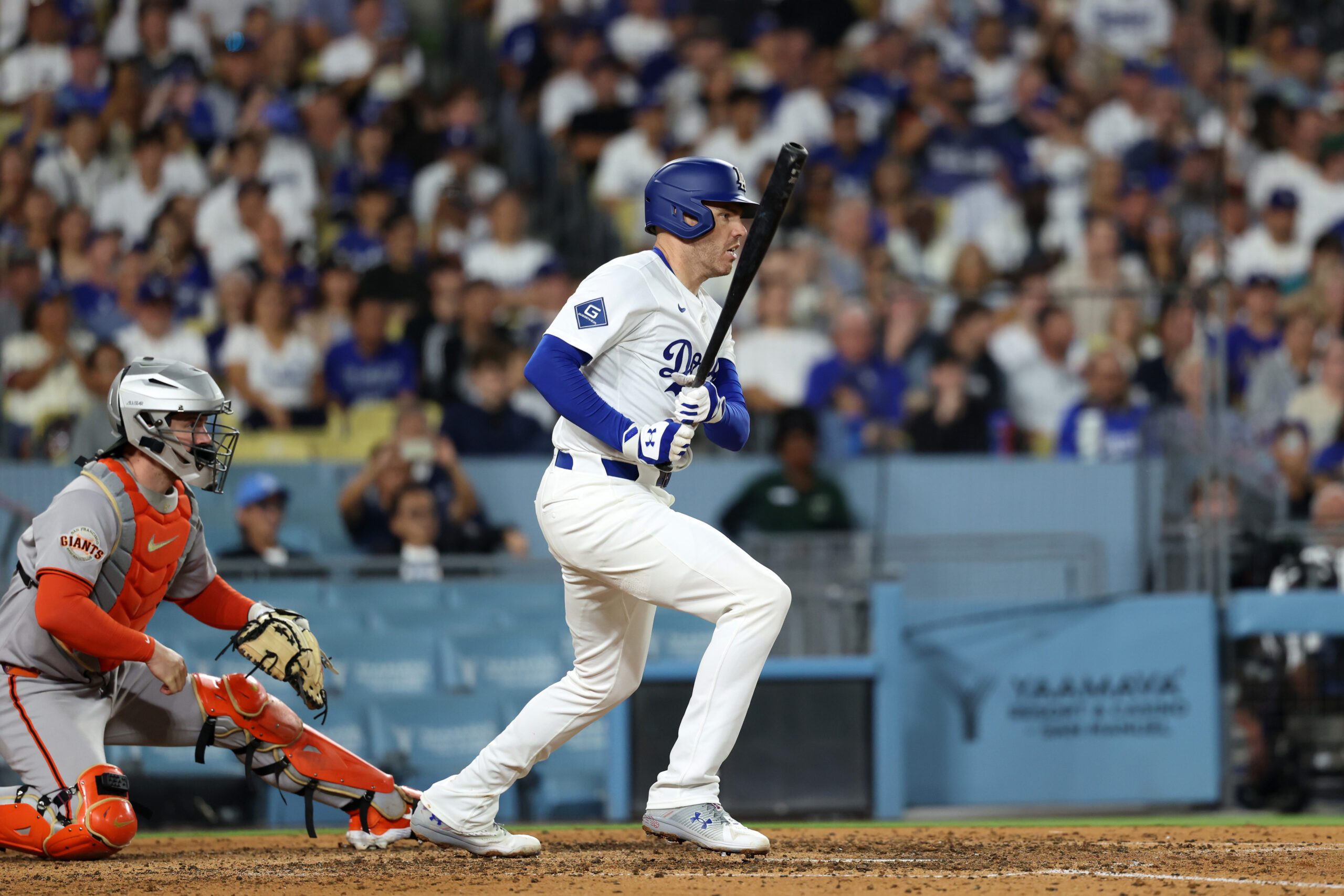 Sep 18, 2025; Los Angeles, California, USA;  Los Angeles Dodgers first baseman Freddie Freeman (5) hits an RBI single during the sixth inning against the San Francisco Giants at Dodger Stadium. Mandatory Credit: Kiyoshi Mio-Imagn Images