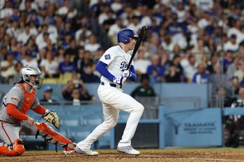 Sep 18, 2025; Los Angeles, California, USA;  Los Angeles Dodgers first baseman Freddie Freeman (5) hits an RBI single during the sixth inning against the San Francisco Giants at Dodger Stadium. Mandatory Credit: Kiyoshi Mio-Imagn Images