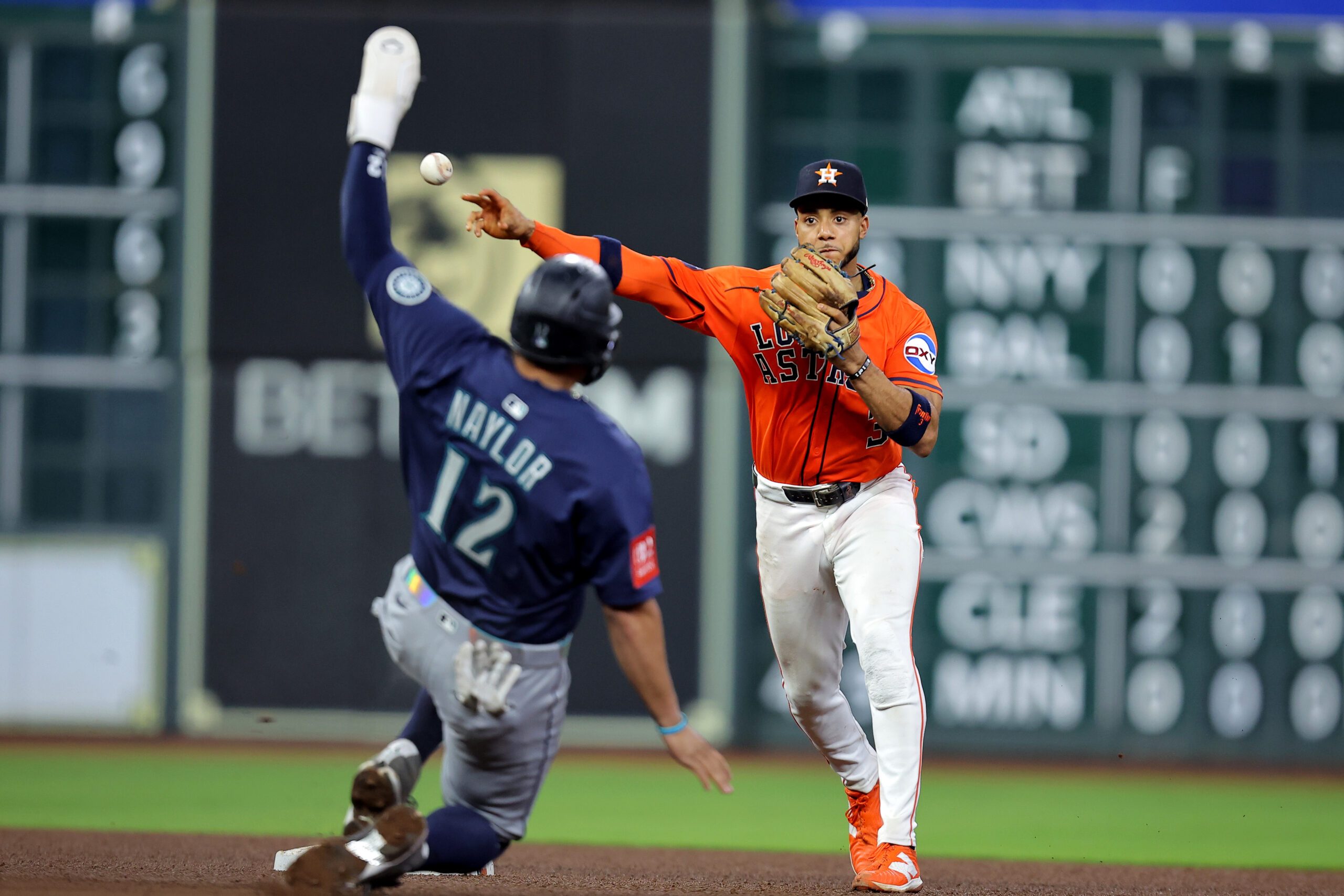 Sep 19, 2025; Houston, Texas, USA; Houston Astros shortstop Jeremy Pena (3) throws a fielded ball to first base after tagging out Seattle Mariners first baseman Josh Naylor (12) during the sixth inning at Daikin Park. Mandatory Credit: Erik Williams-Imagn Images