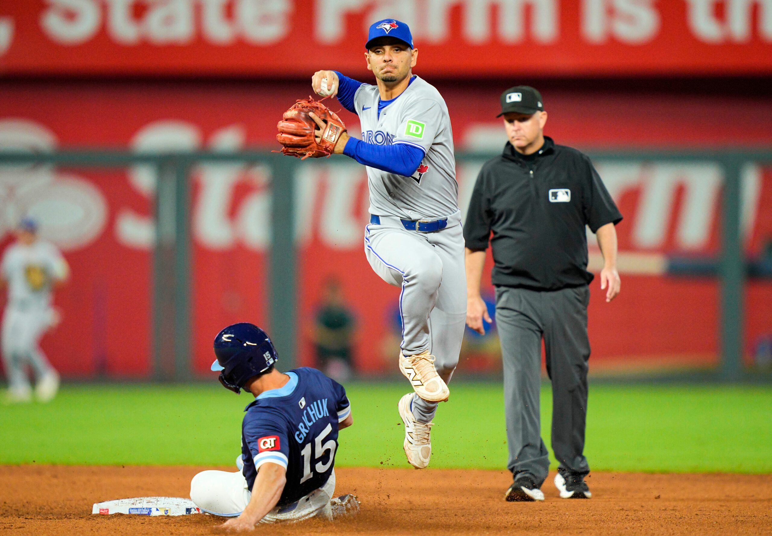 Sep 19, 2025; Kansas City, Missouri, USA; Toronto Blue Jays shortstop Andres Gimenez (0) forces out Kansas City Royals right fielder Randal Grichuk (15) during the seventh inning at Kauffman Stadium. Mandatory Credit: Jay Biggerstaff-Imagn Images