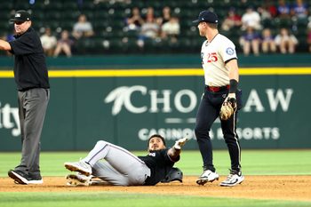 Sep 19, 2025; Arlington, Texas, USA;  Miami Marlins center fielder Dane Myers (54) stares at Texas Rangers second baseman Dylan Moore (25) at second base during the twelfth inning at Globe Life Field. Mandatory Credit: Kevin Jairaj-Imagn Images
