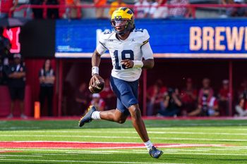 Sep 20, 2025; Lincoln, Nebraska, USA; Michigan Wolverines quarterback Bryce Underwood (19) scrambles against the Nebraska Cornhuskers during the third quarter at Memorial Stadium. Mandatory Credit: Dylan Widger-Imagn Images