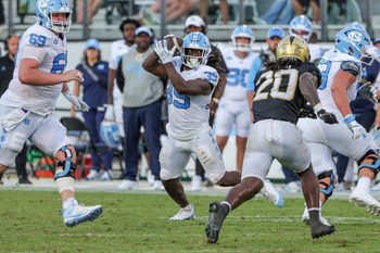 Sep 20, 2025; Orlando, Florida, USA; North Carolina Tar Heels running back Demon June (12) catches a pass during the second half against the UCF Knightsat the Bounce House Stadium. Mandatory Credit: Mike Watters-Imagn Images