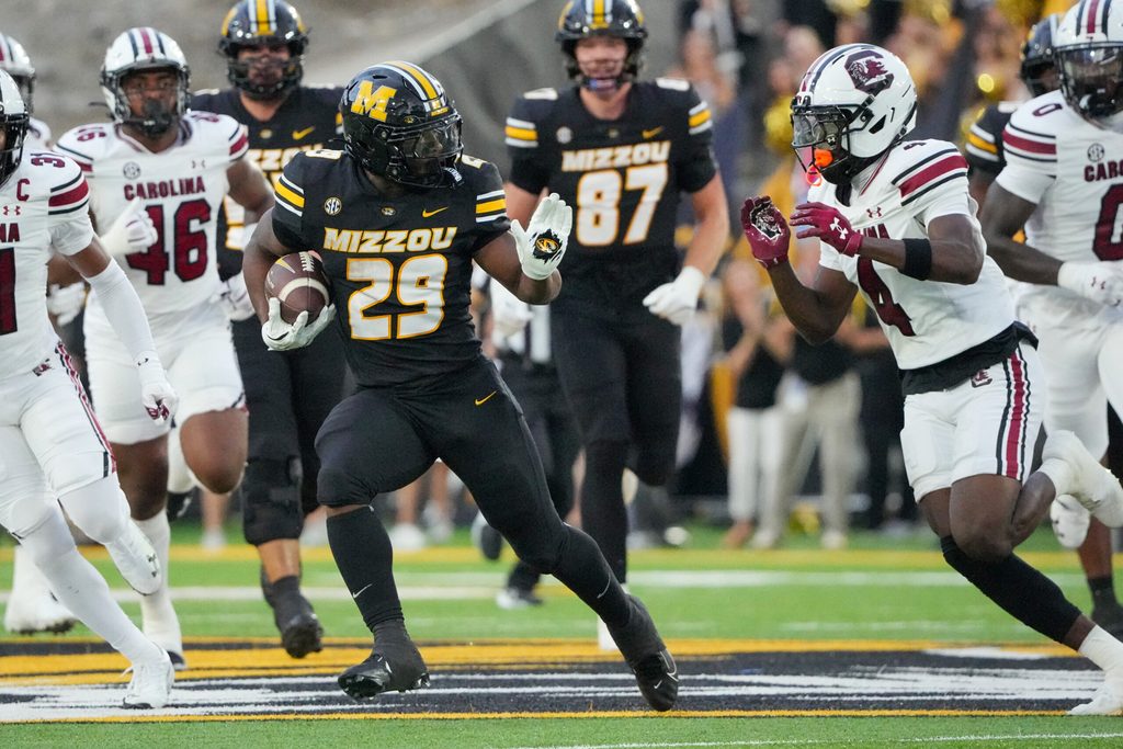 Sep 20, 2025; Columbia, Missouri, USA; Missouri Tigers running back Ahmad Hardy (29) runs the ball as South Carolina Gamecocks defensive back Vicari Swain (4) defends during the first half of the game at Faurot Field at Memorial Stadium. Mandatory Credit: Denny Medley-Imagn Images