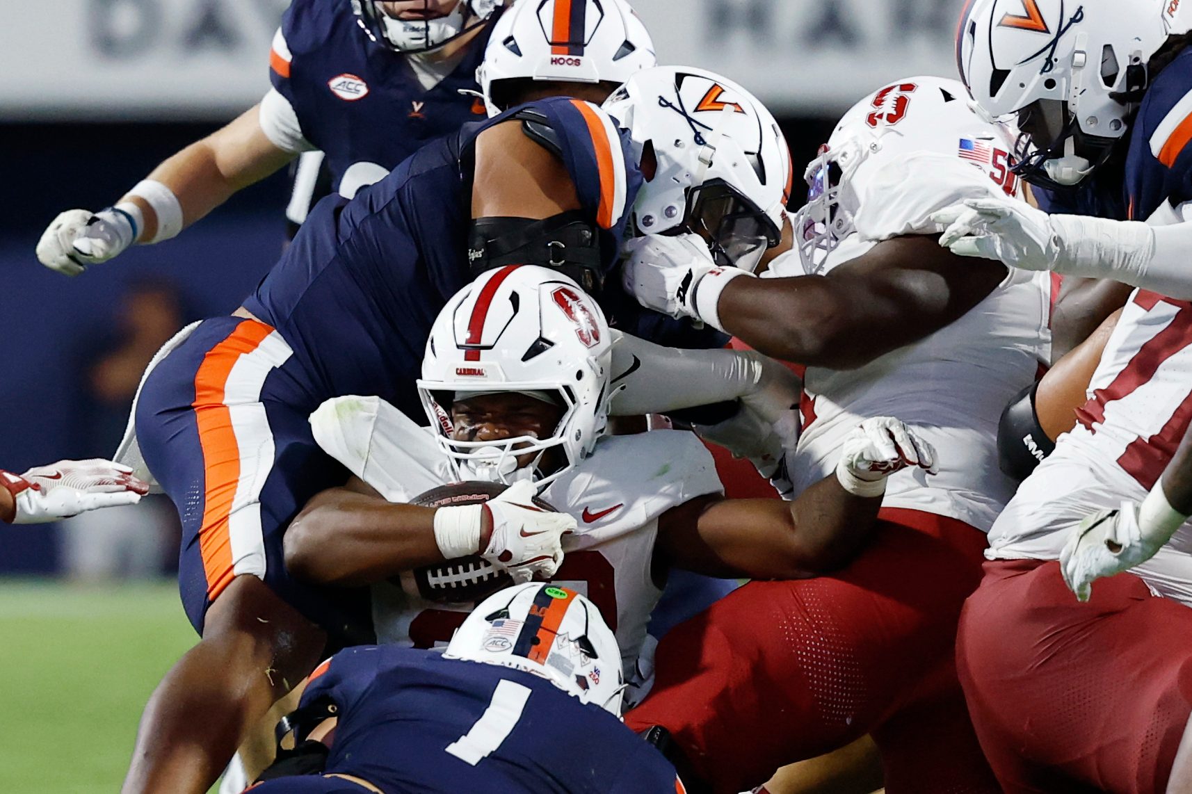 Sep 20, 2025; Charlottesville, Virginia, USA; Stanford Cardinal running back Micah Ford (20) is tackled by Virginia Cavaliers linebacker James Jackson (1) while carrying the ball on a fourth down conversion during the fourth quarter at Scott Stadium. Mandatory Credit: Geoff Burke-Imagn Images