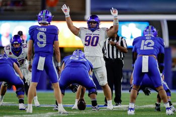Sep 20, 2025; Colorado Springs, Colorado, USA; Boise State Broncos defensive lineman Braxton Fely (90) motions at the line of scrimmage against Air Force Falcons guard Costen Cooley (67) and quarterback Liam Szarka (9) and fullback Terrence Gist (12) in the fourth quarter at Falcon Stadium. Mandatory Credit: Isaiah J. Downing-Imagn Images