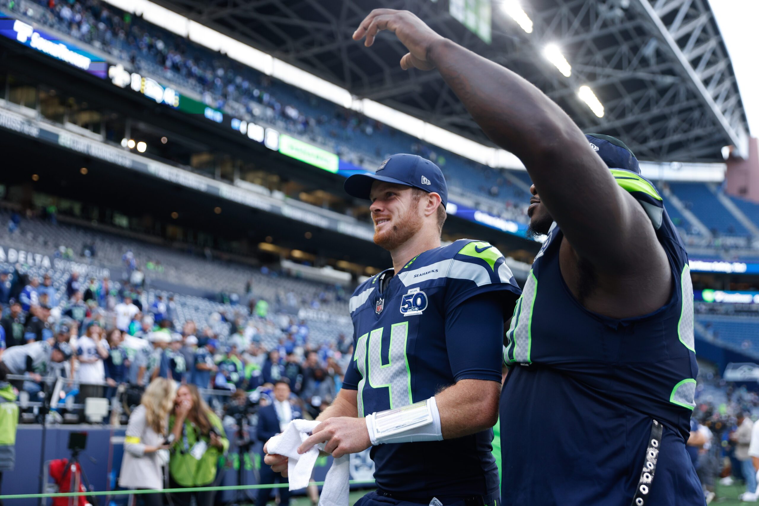 Sep 21, 2025; Seattle, Washington, USA; Seattle Seahawks quarterback Sam Darnold (14) walks off the field after the game against the New Orleans Saints at Lumen Field. Mandatory Credit: Joe Nicholson-Imagn Images