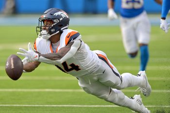 Sep 21, 2025; Inglewood, California, USA;  Denver Broncos wide receiver Courtland Sutton (14) reaches for a long pass 4th down in the second half against the Los Angeles Chargers at SoFi Stadium. Mandatory Credit: Jayne Kamin-Oncea-Imagn Images