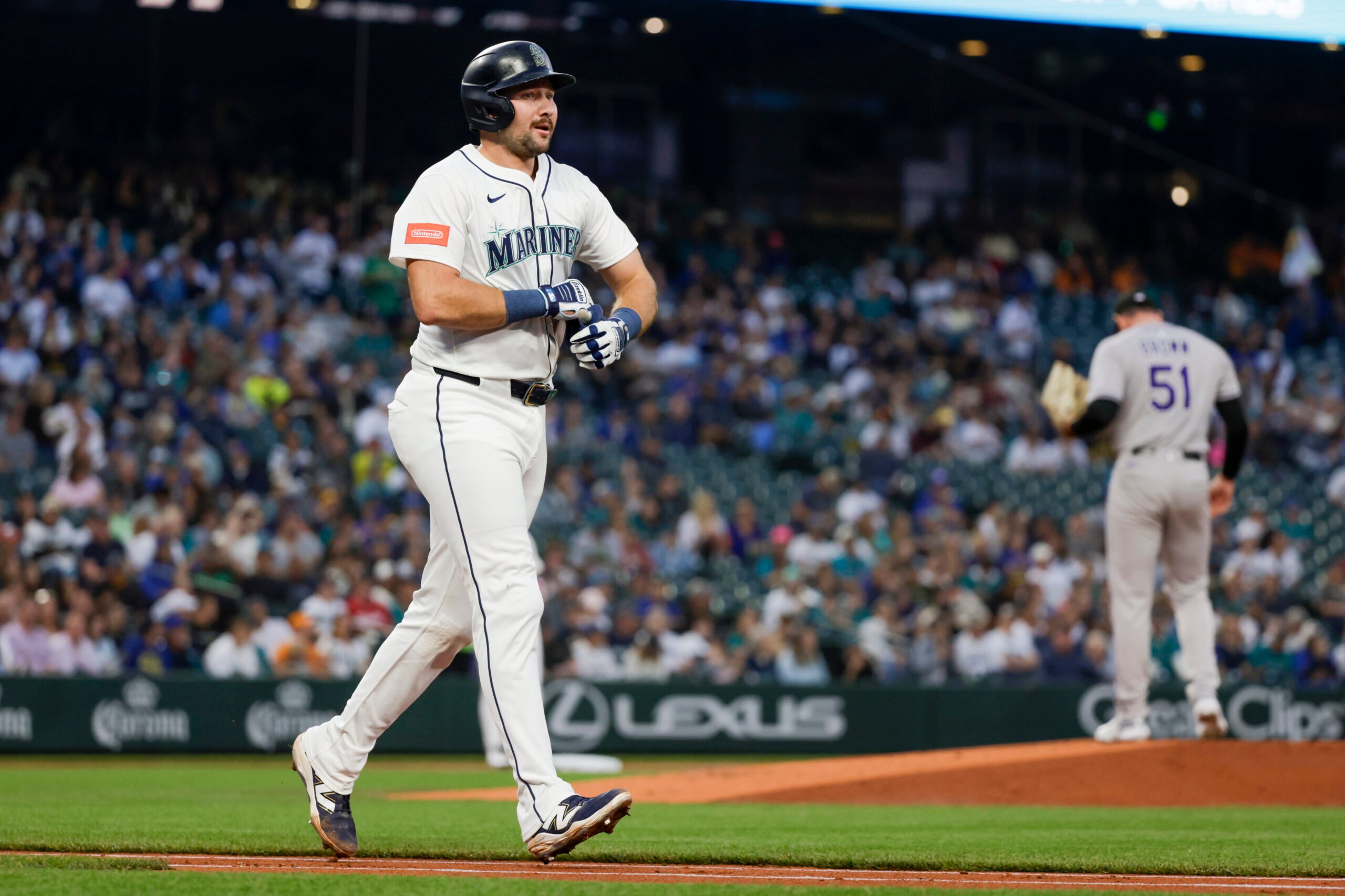 Sep 23, 2025; Seattle, Washington, USA; Seattle Mariners catcher Cal Raleigh (29) advances to first base after being struck by a pitch against the Colorado Rockies during the first inning at T-Mobile Park. Mandatory Credit: Joe Nicholson-Imagn Images