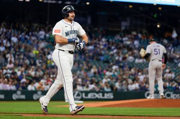 Sep 23, 2025; Seattle, Washington, USA; Seattle Mariners catcher Cal Raleigh (29) advances to first base after being struck by a pitch against the Colorado Rockies during the first inning at T-Mobile Park. Mandatory Credit: Joe Nicholson-Imagn Images