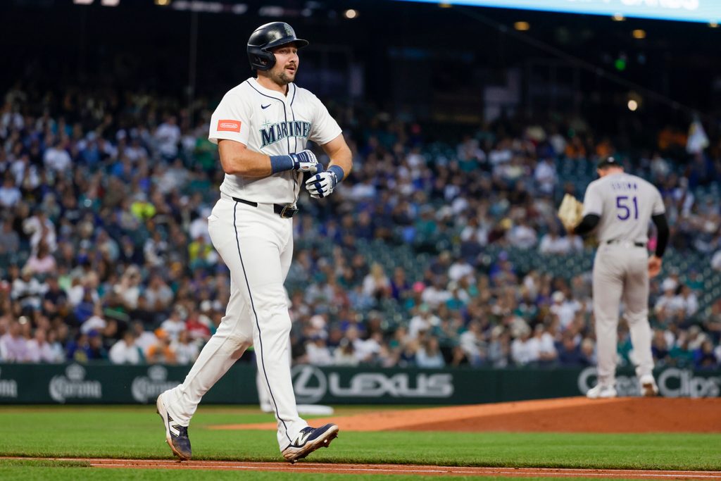 Sep 23, 2025; Seattle, Washington, USA; Seattle Mariners catcher Cal Raleigh (29) advances to first base after being struck by a pitch against the Colorado Rockies during the first inning at T-Mobile Park. Mandatory Credit: Joe Nicholson-Imagn Images
