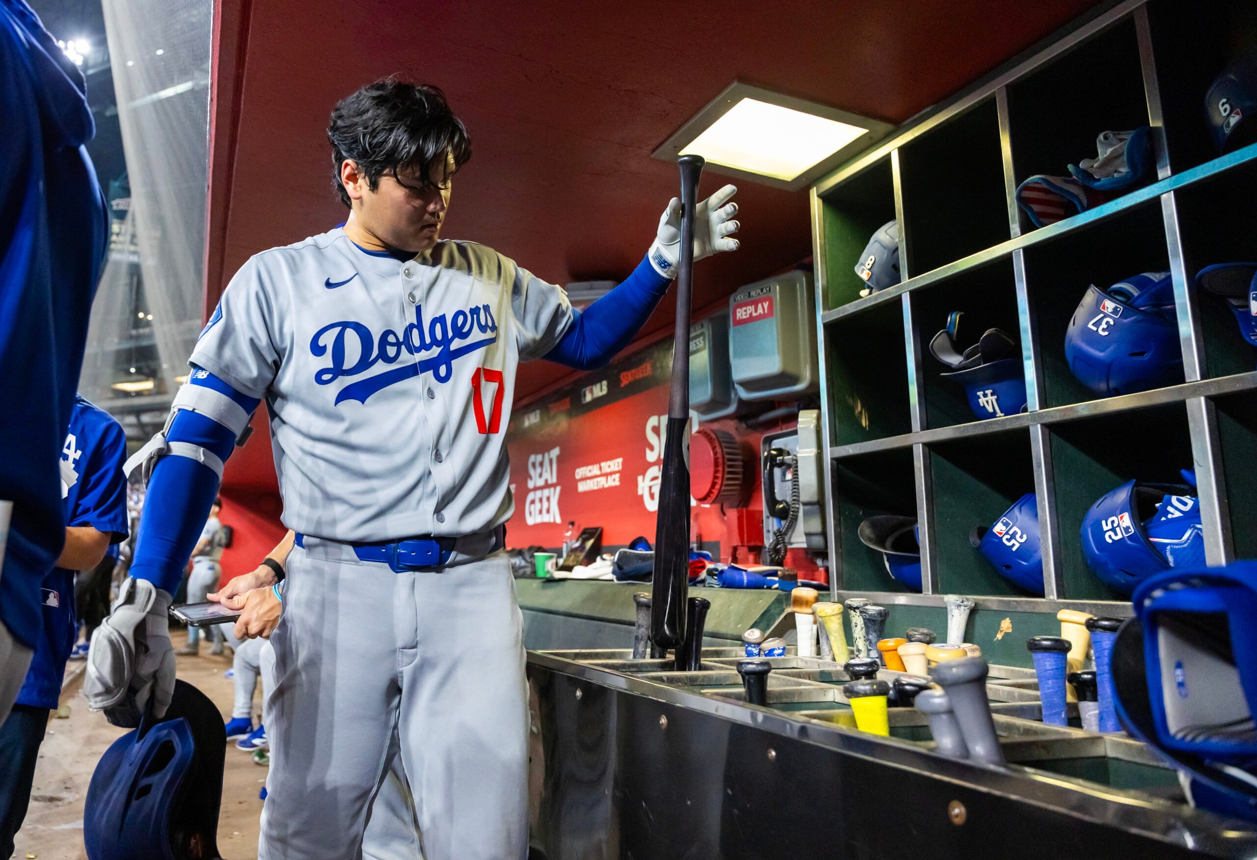 Sep 23, 2025; Phoenix, Arizona, USA; Los Angeles Dodgers designated hitter Shohei Ohtani grabs his bat in the eighth inning against the Arizona Diamondbacks at Chase Field. Mandatory Credit: Mark J. Rebilas-Imagn Images