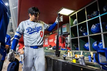 Sep 23, 2025; Phoenix, Arizona, USA; Los Angeles Dodgers designated hitter Shohei Ohtani grabs his bat in the eighth inning against the Arizona Diamondbacks at Chase Field. Mandatory Credit: Mark J. Rebilas-Imagn Images