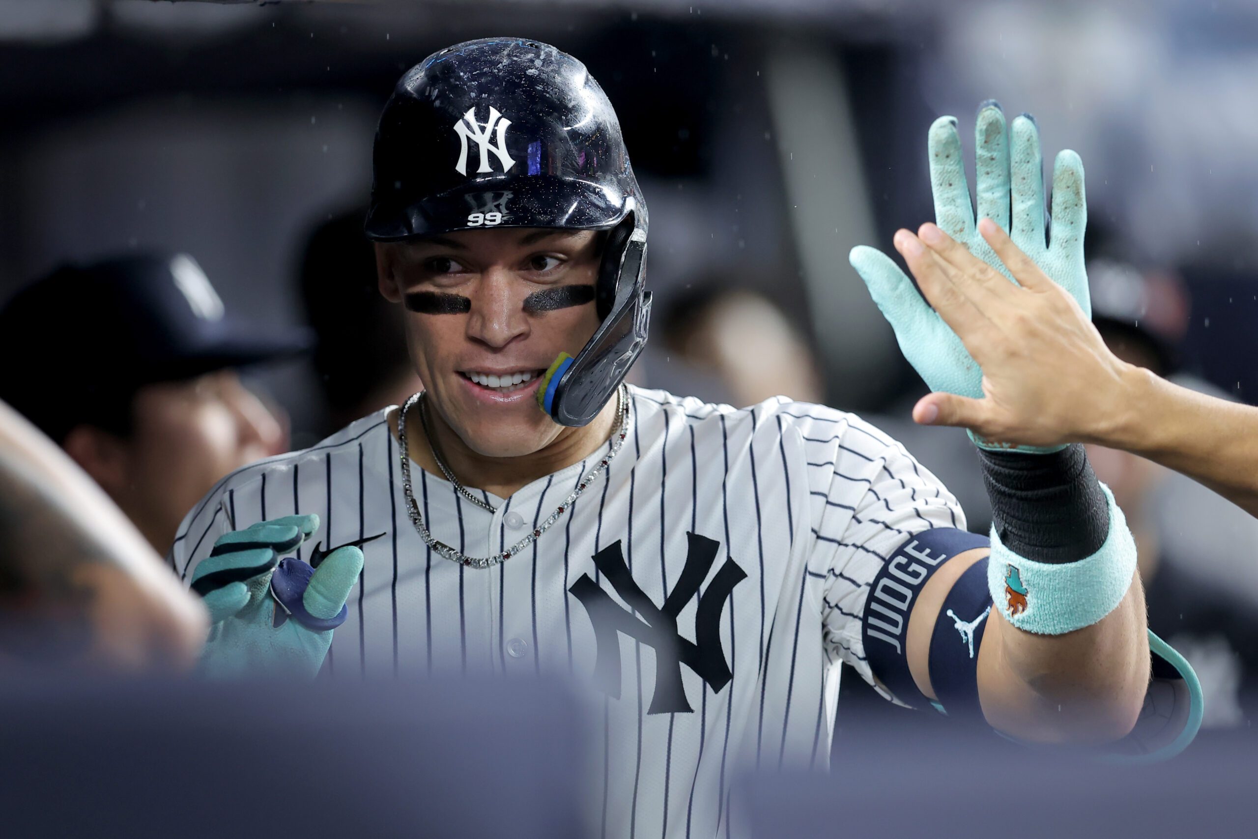 Sep 24, 2025; Bronx, New York, USA; New York Yankees right fielder Aaron Judge (99) celebrates his solo home run against the Chicago White Sox with teammates in the dugout during the eighth inning at Yankee Stadium. Mandatory Credit: Brad Penner-Imagn Images