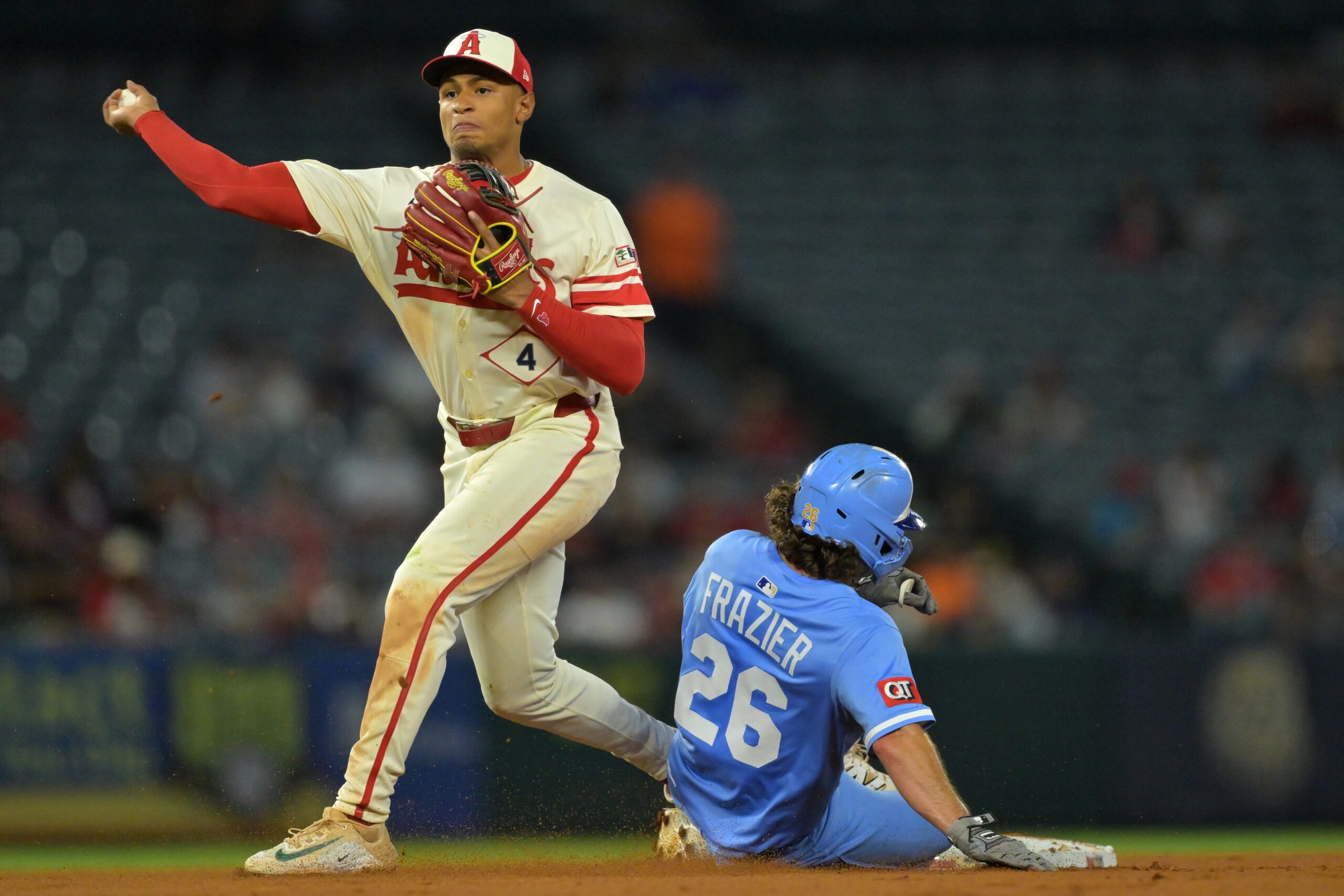 Sep 24, 2025; Anaheim, California, USA;  Kansas City Royals second baseman Adam Frazier (26) is out as Los Angeles Angels second baseman Christian Moore (4) throws to first for a double play in the eighth inning at Angel Stadium. Mandatory Credit: Jayne Kamin-Oncea-Imagn Images