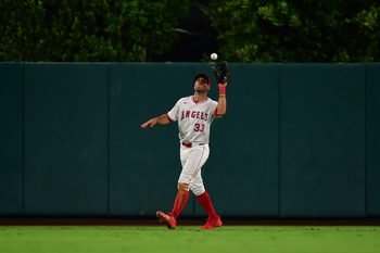 Sep 26, 2025; Anaheim, California, USA; Los Angeles Angels outfielder Chris Taylor (33) catches the fly ball of Houston Astros pinch hitter Victor Caratini (17) during the eighth inning at Angel Stadium. Mandatory Credit: Gary A. Vasquez-Imagn Images
