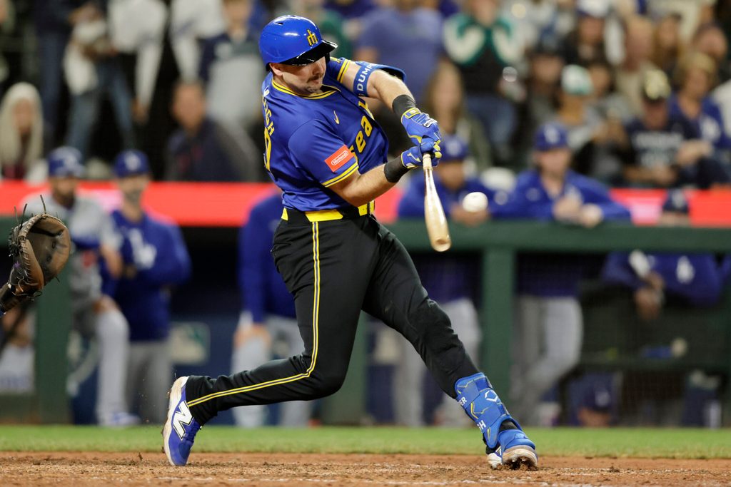 Sep 26, 2025; Seattle, Washington, USA; Seattle Mariners catcher Cal Raleigh (29) hits a double against the Los Angeles Dodgers during the ninth inning at T-Mobile Park. Mandatory Credit: John Froschauer-Imagn Images