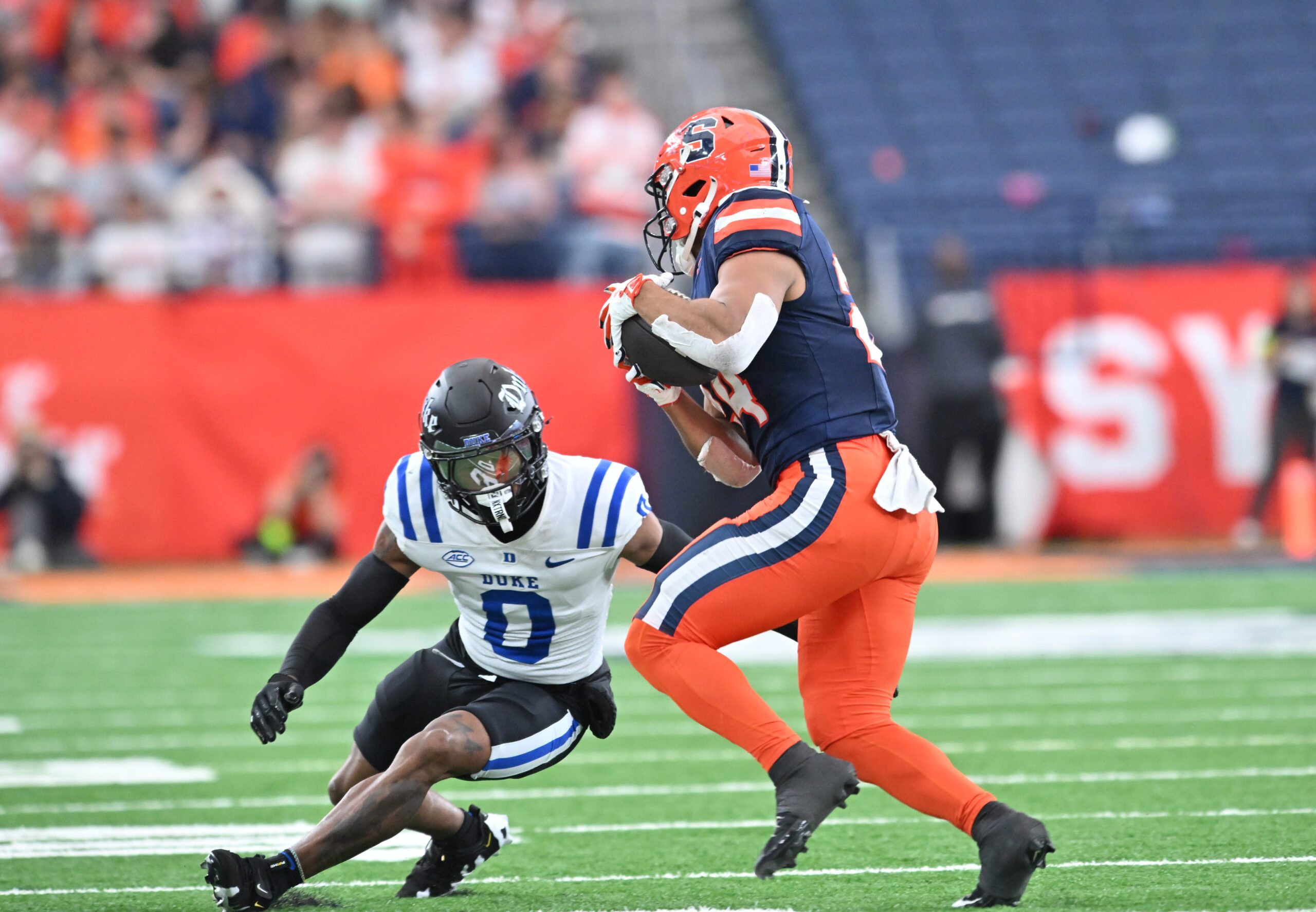 Sep 27, 2025; Syracuse, New York, USA; Duke Blue Devils cornerback Chandler Rivers (0) tries to tackle Syracuse Orange running back Will Nixon (24) in the second quarter at the JMA Wireless Dome. Mandatory Credit: Mark Konezny-Imagn Images