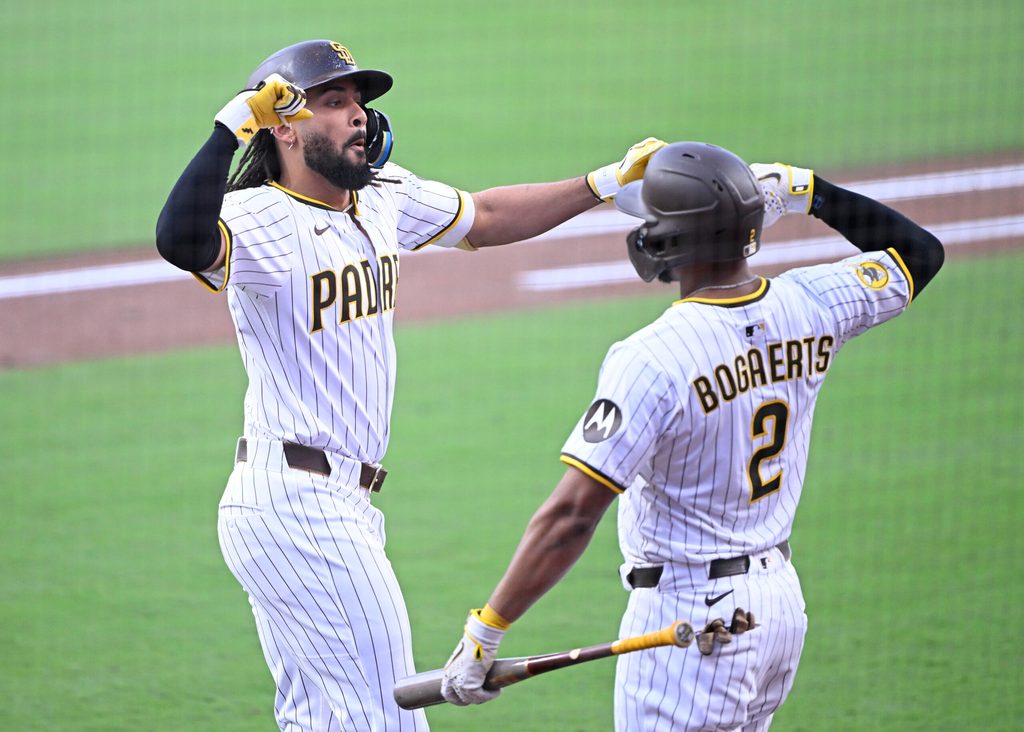 Sep 27, 2025; San Diego, California, USA; San Diego Padres right fielder Fernando Tatis Jr. (23) is congratulated by Luis Arraez (4) after hitting a solo home run during the first inning against the Arizona Diamondbacks at Petco Park. Mandatory Credit: Denis Poroy-Imagn Images