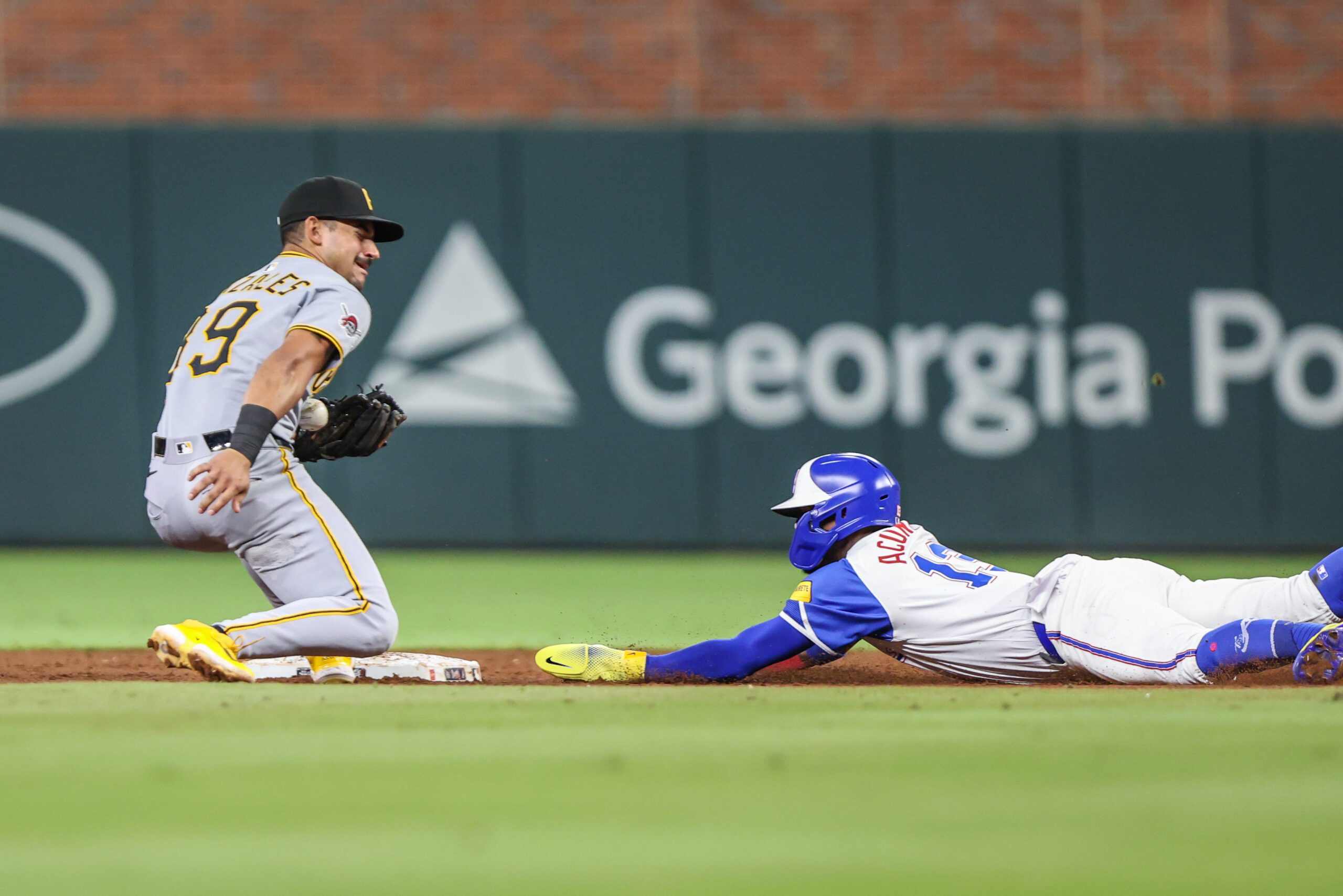Sep 27, 2025; Cumberland, Georgia, USA; Atlanta Braves outfielder Ronald Acuna Jr. (13) steals second base against Pittsburgh Pirates shortstop Jared Triolo (19) during the ninth inning at Truist Park. Mandatory Credit: Jordan Godfree-Imagn Images