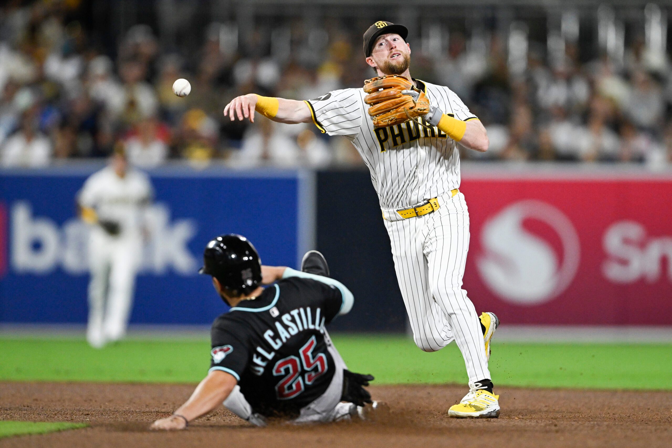 Sep 27, 2025; San Diego, California, USA; San Diego Padres second baseman Jake Cronenworth (9) throws over Arizona Diamondbacks catcher Adrian Del Castillo (25) as he turns a double play during the fifth inning at Petco Park. Mandatory Credit: Denis Poroy-Imagn Images