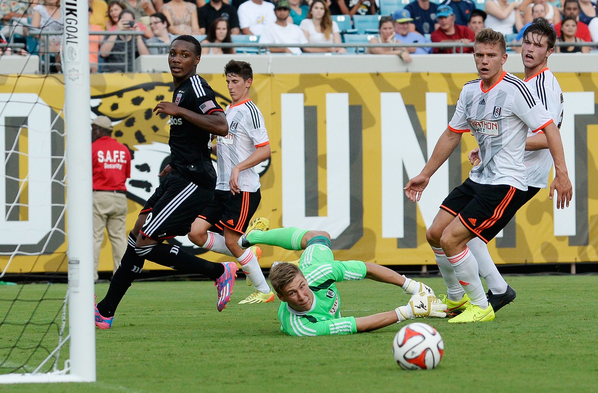 Jul 26, 2014; Jacksonville, FL, USA; Fulham FC goalie Jesse Joronen (41) makes a diving save against D.C. United forward Michael Seaton (29) at EverBank Field. Mandatory Credit: Richard Dole-Imagn Images
