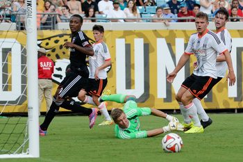 Jul 26, 2014; Jacksonville, FL, USA; Fulham FC goalie Jesse Joronen (41) makes a diving save against D.C. United forward Michael Seaton (29) at EverBank Field. Mandatory Credit: Richard Dole-Imagn Images