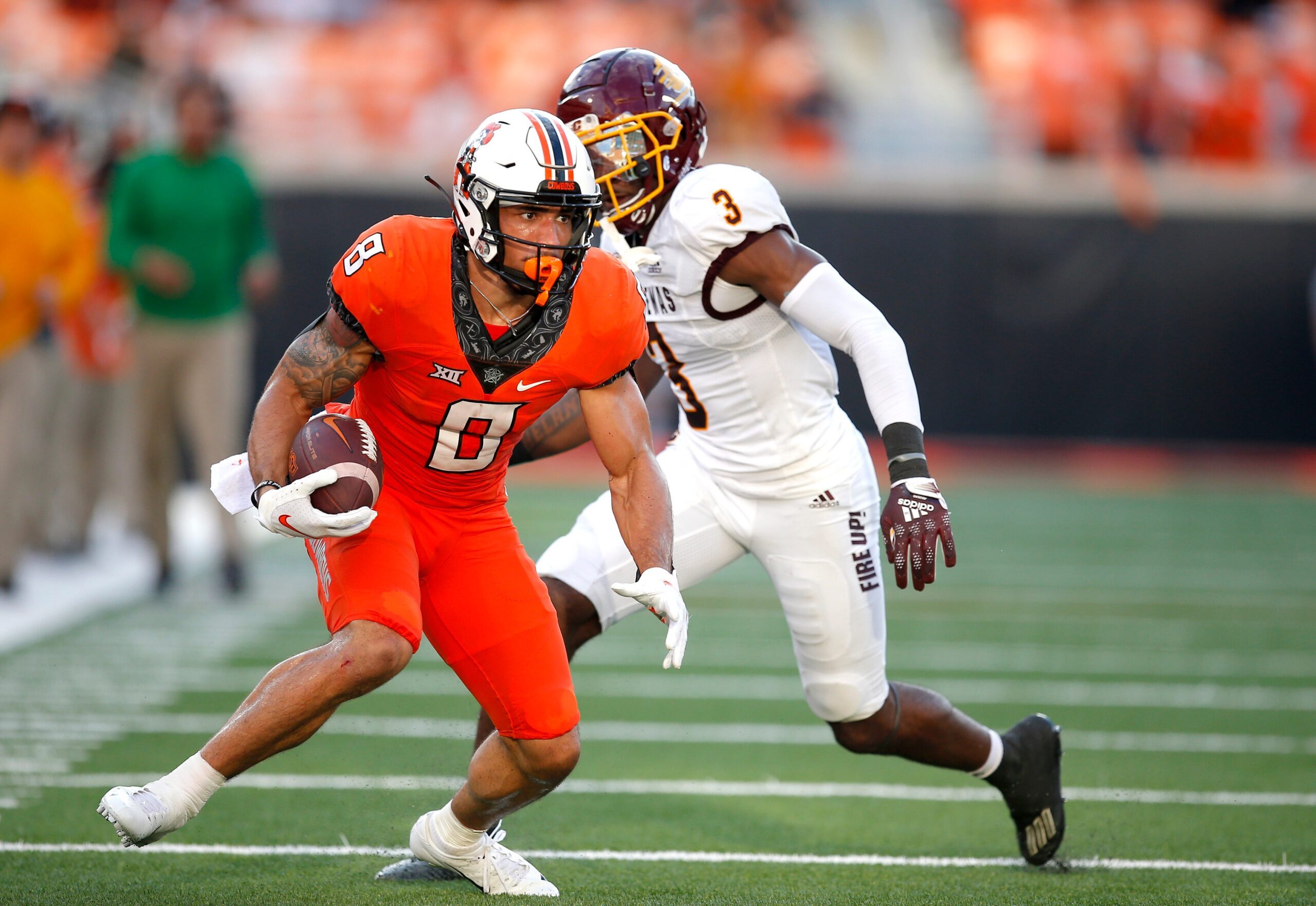 Oklahoma State's Ollie Gordon (0) rushes after a reception as Central Michigan's Trey Jones (3) defends in the second quarter during the college football game between the Oklahoma State Cowboys and Central Michigan Chippewa at Boone Pickens Stadium in Stillwater, Oka., Thursday, Sept., 1, 2022. OSU won 58-44.

Osu Vs Central Michigan
