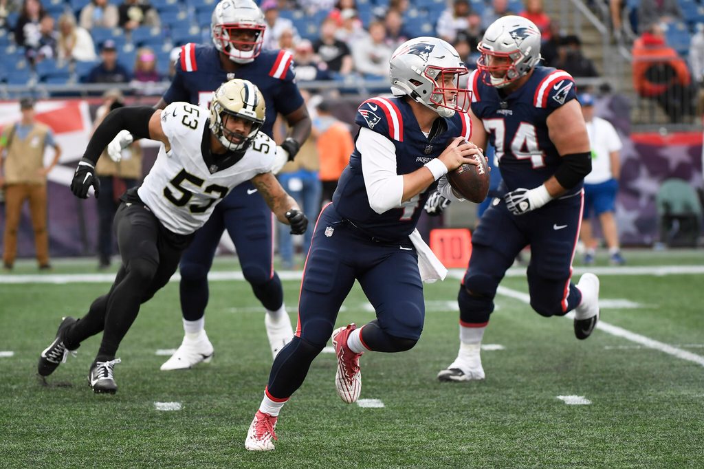 Oct 8, 2023; Foxborough, Massachusetts, USA; New England Patriots quarterback Bailey Zappe (4) runs with the ball during the second half against the New Orleans Saints at Gillette Stadium. Mandatory Credit: Bob DeChiara-Imagn Images