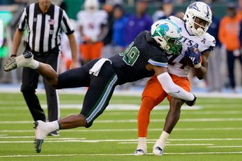 Nov 24, 2023; New Orleans, Louisiana, USA; Tulane Green Wave linebacker Jesus Machado (99) tackles UTSA Roadrunners running back Rocko Griffin (24) during the second half at Yulman Stadium. Mandatory Credit: Matthew Hinton-Imagn Images