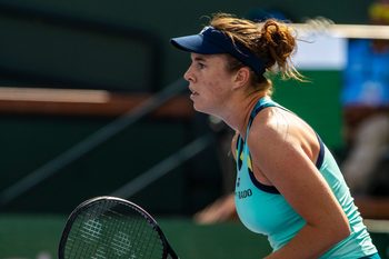 Linda Noskova awaits a serve from Iga Swiatek during round three of the BNP Paribas Open in Indian Wells, Calif., Sunday, March 10, 2024.