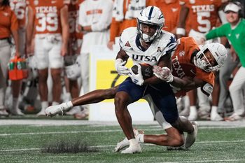 Sep 14, 2024; Austin, Texas, USA; Texas Longhorns defensive back Warren Roberson (24) tackles Texas Roadrunners wide receiver Devin McCuin (3) during the second half at Darrell K Royal-Texas Memorial Stadium. Mandatory Credit: Scott Wachter-Imagn Images