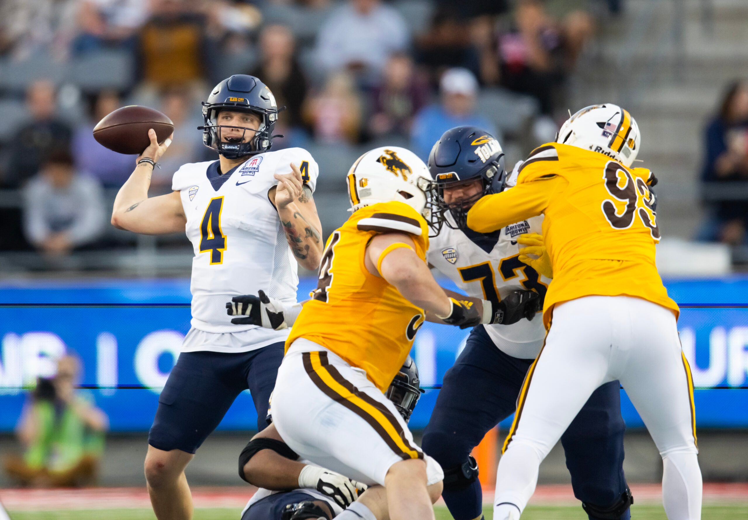 Dec 30, 2023; Tucson, AZ, USA; Toledo Rockets quarterback Tucker Gleason (4) against the Wyoming Cowboys in the Arizona Bowl at Arizona Stadium. Mandatory Credit: Mark J. Rebilas-USA TODAY Sports