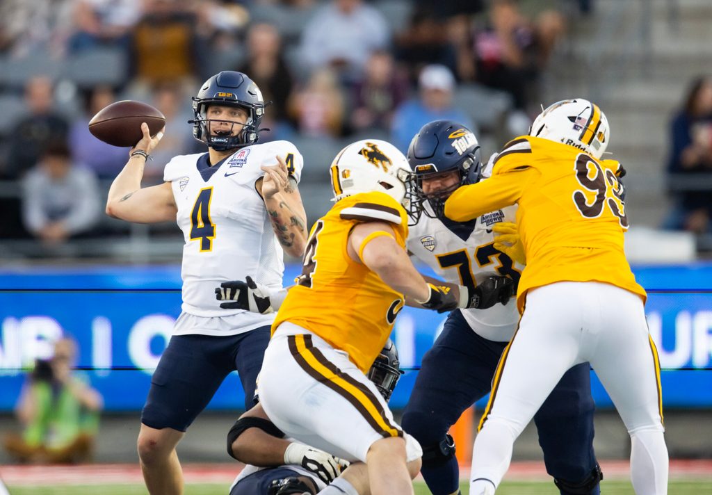 Dec 30, 2023; Tucson, AZ, USA; Toledo Rockets quarterback Tucker Gleason (4) against the Wyoming Cowboys in the Arizona Bowl at Arizona Stadium. Mandatory Credit: Mark J. Rebilas-USA TODAY Sports