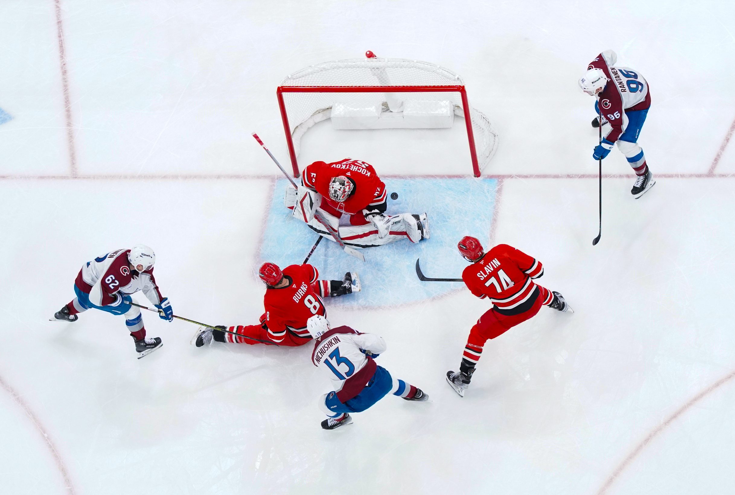 Dec 5, 2024; Raleigh, North Carolina, USA;  Colorado Avalanche right wing Valeri Nichushkin (13) scores a goal past Carolina Hurricanes goaltender Pyotr Kochetkov (52)  defenseman Brent Burns (8) and defenseman Jaccob Slavin (74) during the third period at Lenovo Center. Mandatory Credit: James Guillory-Imagn Images