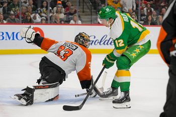 Dec 14, 2024; Saint Paul, Minnesota, USA;  Minnesota Wild forward Matt Boldy (12) scores a breakaway goal against  Philadelphia Flyers goalie Samuel Ersson (33) during the second period at Xcel Energy Center. Mandatory Credit: Nick Wosika-Imagn Images