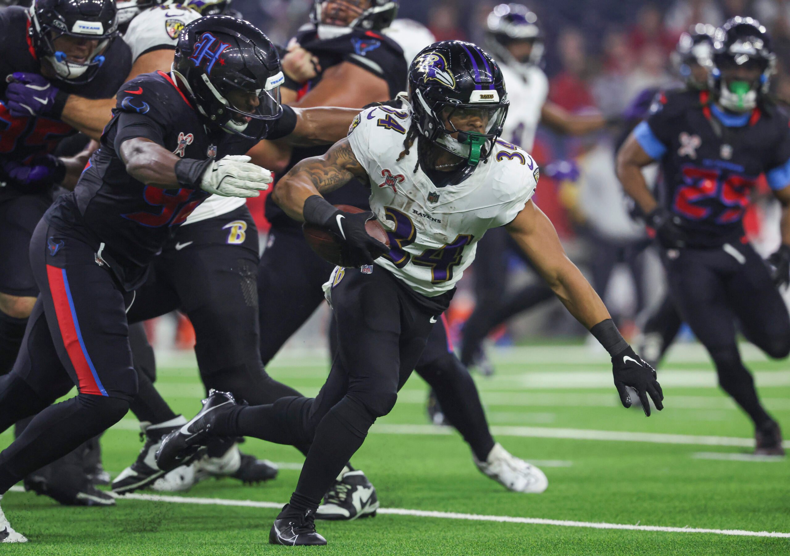 Dec 25, 2024; Houston, Texas, USA;  Baltimore Ravens running back Keaton Mitchell (34) runs with the ball during the fourth quarter against the Houston Texans at NRG Stadium. Mandatory Credit: Troy Taormina-Imagn Images