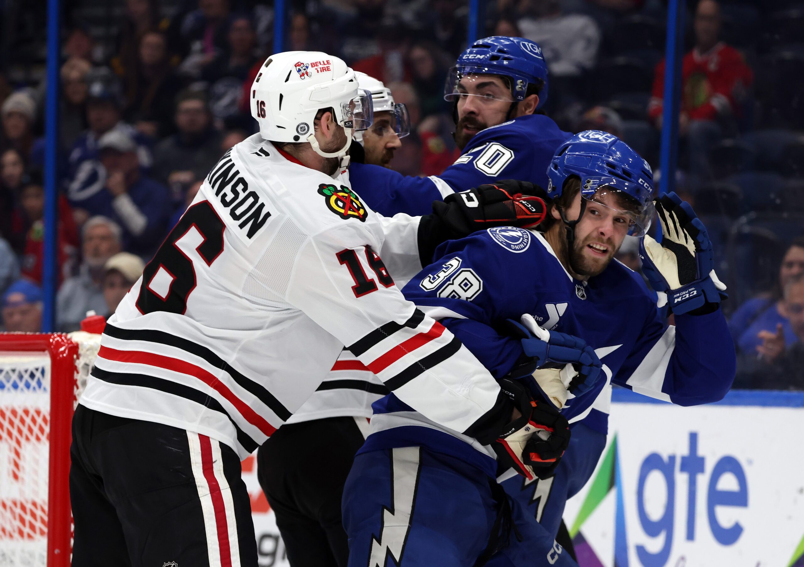 Jan 28, 2025; Tampa, Florida, USA; Chicago Blackhawks center Jason Dickinson (16) and Tampa Bay Lightning left wing Brandon Hagel (38) fight during the third period at Amalie Arena. Mandatory Credit: Kim Klement Neitzel-Imagn Images