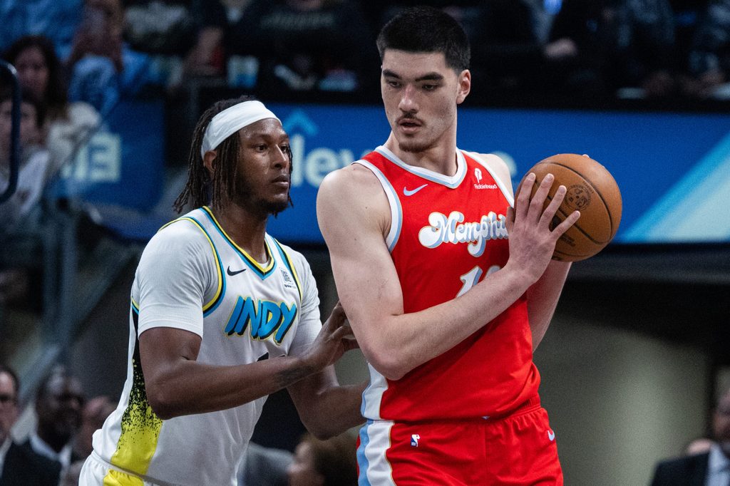 Feb 20, 2025; Indianapolis, Indiana, USA; Memphis Grizzlies center Zach Edey (14) holds the ball while Indiana Pacers center Myles Turner (33) defends in the second half at Gainbridge Fieldhouse. Mandatory Credit: Trevor Ruszkowski-Imagn Images