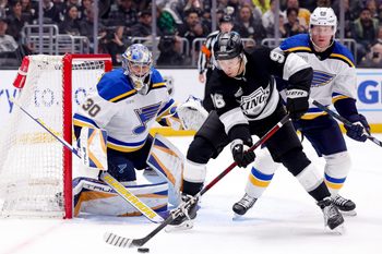 Mar 8, 2025; Los Angeles, California, USA; Los Angeles Kings left wing Andrei Kuzmenko (96) looks to shoot ahead of St. Louis Blues defenseman Ryan Suter (22) and goaltender Joel Hofer (30) during the second period at Crypto.com Arena. Mandatory Credit: Ryan Sun-Imagn Images