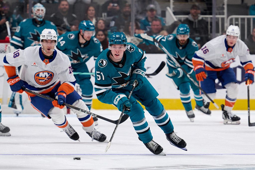 Mar 8, 2025; San Jose, California, USA; San Jose Sharks right wing Collin Graf (51) skates with the puck against New York Islanders left wing Pierre Engvall (18) during the second period at SAP Center at San Jose. Mandatory Credit: Robert Edwards-Imagn Images