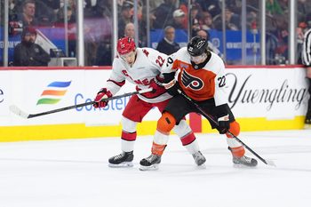 Mar 15, 2025; Philadelphia, Pennsylvania, USA; Carolina Hurricanes center Logan Stankoven (22) and Philadelphia Flyers left wing Jakob Pelletier (22) battle for the puck in the second period at Wells Fargo Center. Mandatory Credit: Kyle Ross-Imagn Images
