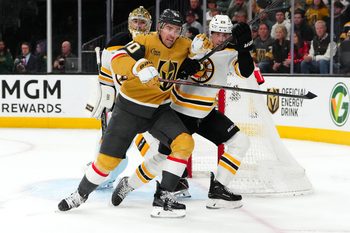 Mar 20, 2025; Las Vegas, Nevada, USA; Vegas Golden Knights left wing Tanner Pearson (70) attempts to skate past Boston Bruins defenseman Parker Wotherspoon (29) in front of Boston Bruins goaltender Jeremy Swayman (1) during the second period at T-Mobile Arena. Mandatory Credit: Stephen R. Sylvanie-Imagn Images