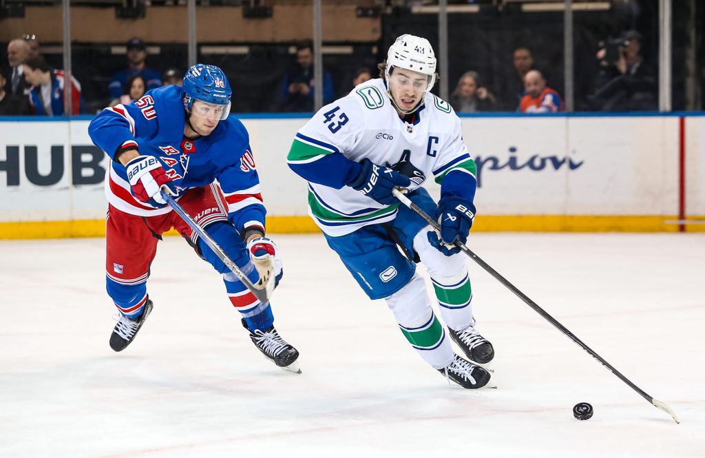 Mar 22, 2025; New York, New York, USA; New York Rangers left wing Will Cuylle (50) chases Vancouver Canucks defenseman Quinn Hughes (43) during the third period at Madison Square Garden. Mandatory Credit: Danny Wild-Imagn Images