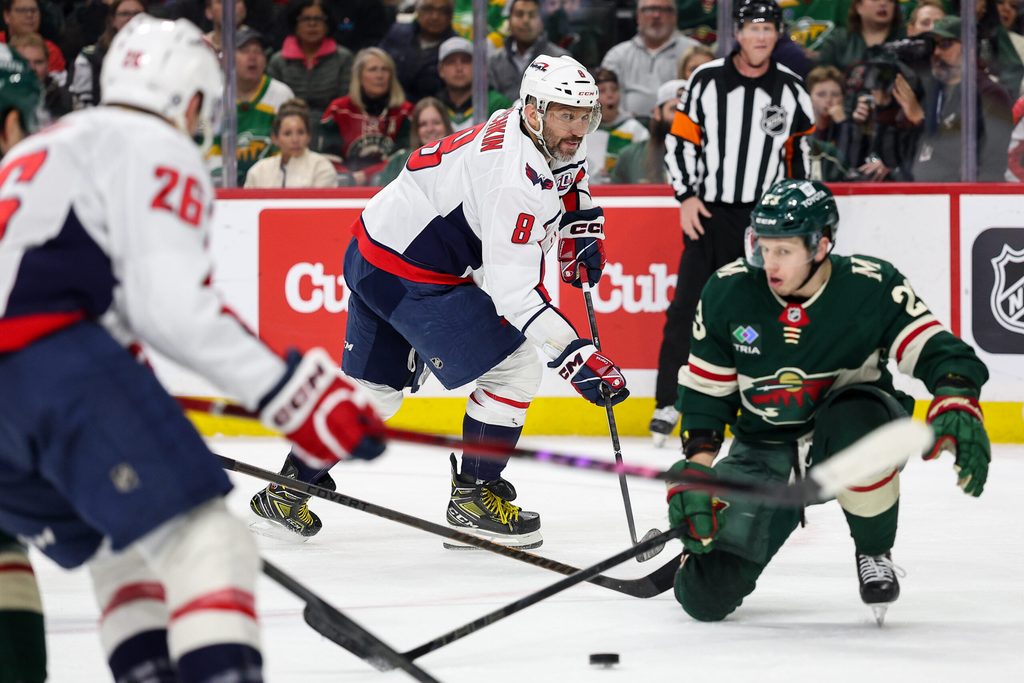 Mar 27, 2025; Saint Paul, Minnesota, USA; Washington Capitals left wing Alex Ovechkin (8) passes the puck against the Minnesota Wild during the second period at Xcel Energy Center. Mandatory Credit: Matt Krohn-Imagn Images