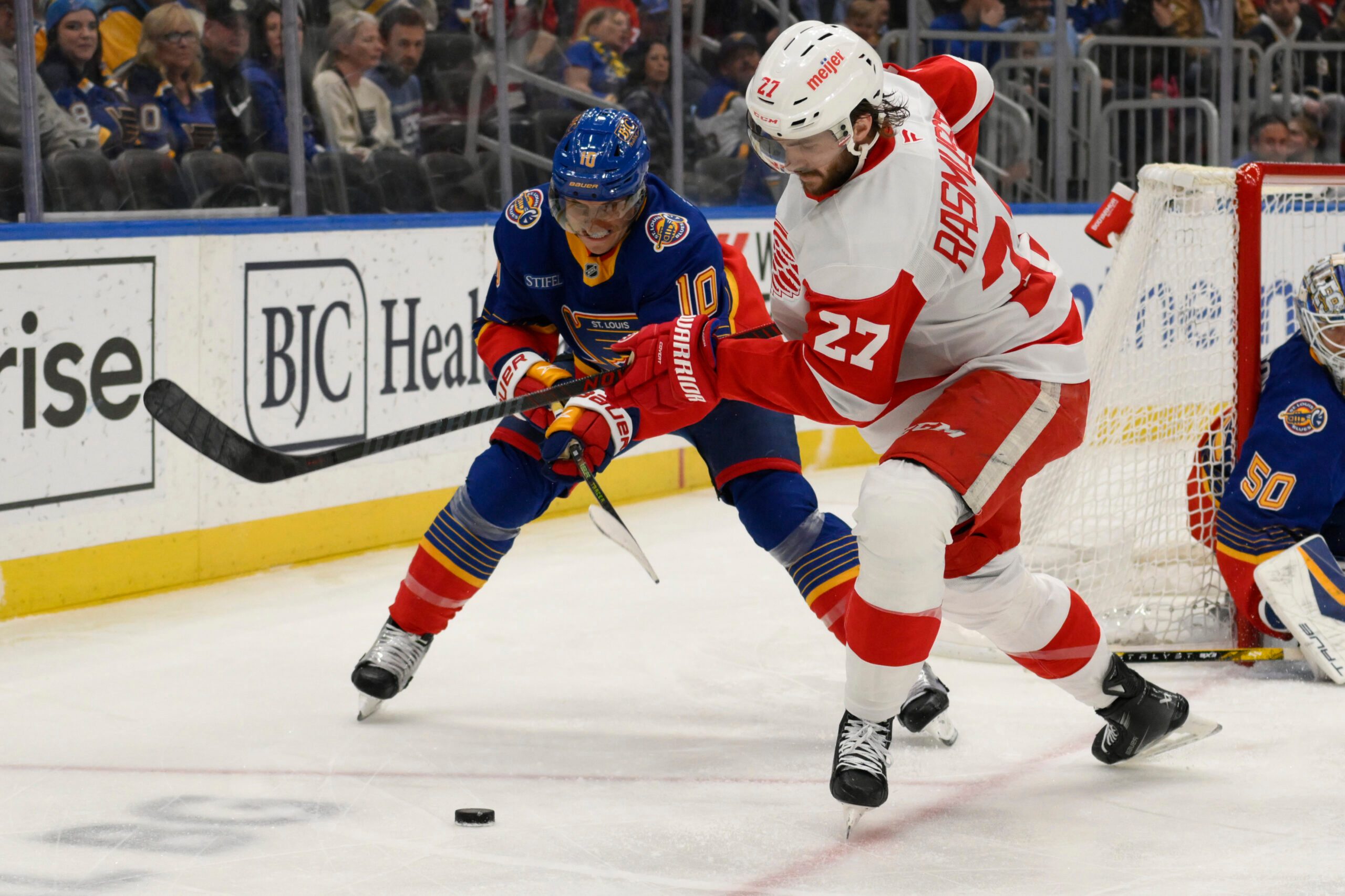 Apr 1, 2025; St. Louis, Missouri, USA; St. Louis Blues center Brayden Schenn (10) battles Detroit Red Wings center Michael Rasmussen (27) during the first period at Enterprise Center. Mandatory Credit: Jeff Le-Imagn Images