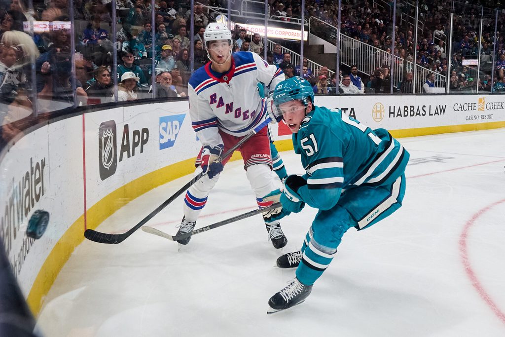 Mar 29, 2025; San Jose, California, USA; New York Rangers defenseman Braden Schneider (4) passes the puck against San Jose Sharks right wing Collin Graf (51) during the second period at SAP Center at San Jose. Mandatory Credit: Robert Edwards-Imagn Images